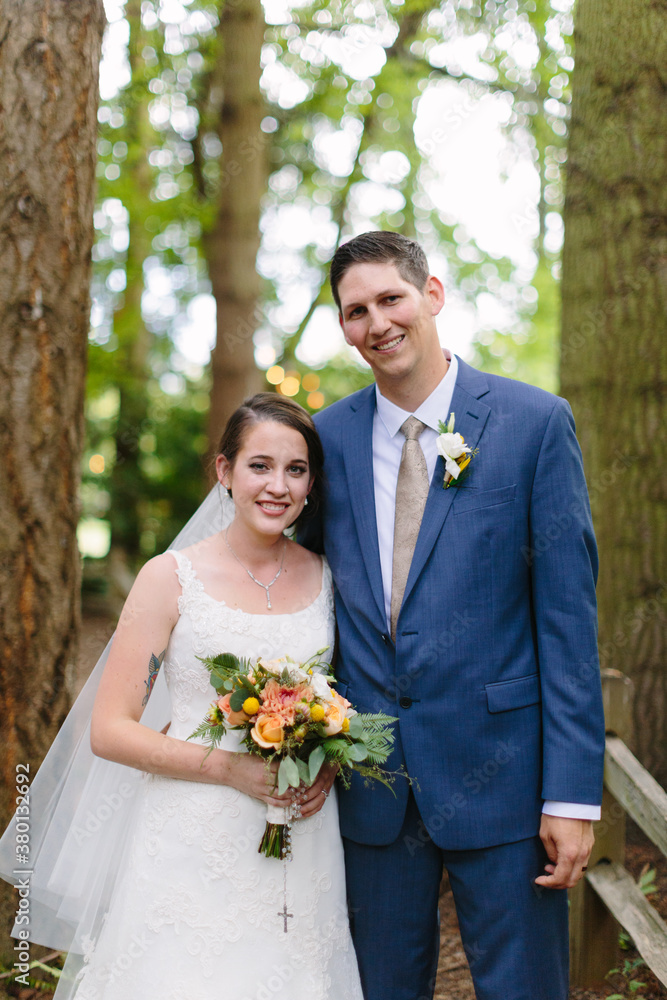 Bride and Groom Standing in Tall Trees Bride and Groom Standing in Tall Trees