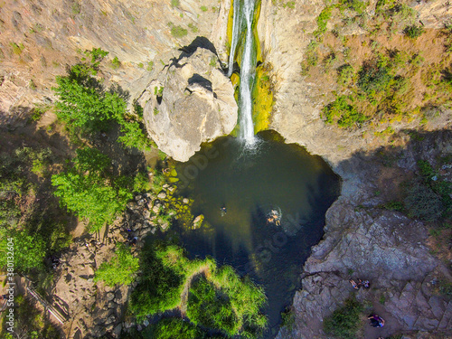 a stunning aerial shot of the waterfall covered in green and yellow algae and the surrounded mountain landscape at Paradise Falls in Thousand Oaks California USA photo