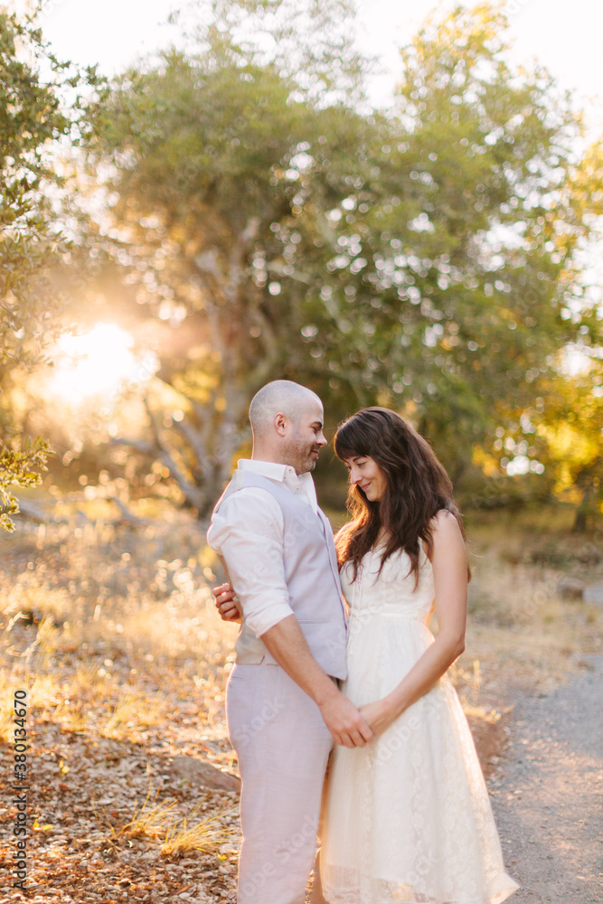 Wedding Couple Holding Hands in Woods at Sunrise Wedding Couple Holding Hands in Woods at Sunrise