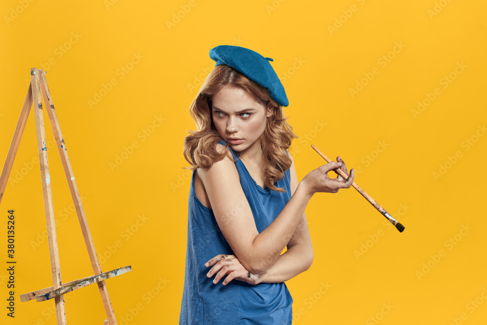 Artist woman in blue beret brush easel art drawing education hobby Creative approach yellow background Artist woman in blue beret brush easel art drawing education hobby Creative approach yellow background
