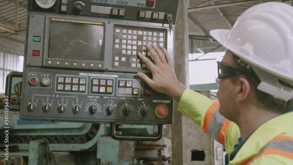 Maintenance engineer control automatic and pressing machine with panel in factory, system computer industrial, young asian man working, tool and equipment, industry and technology concept. Maintenance engineer control automatic and pressing machine with panel in factory, system computer industrial, young asian man working, tool and equipment, industry and technology concept.