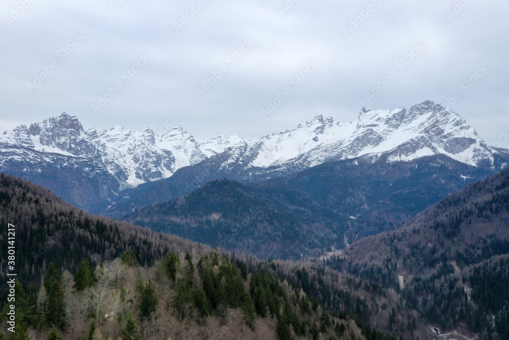 aerial snow covered mountain peaks in alps at winter 