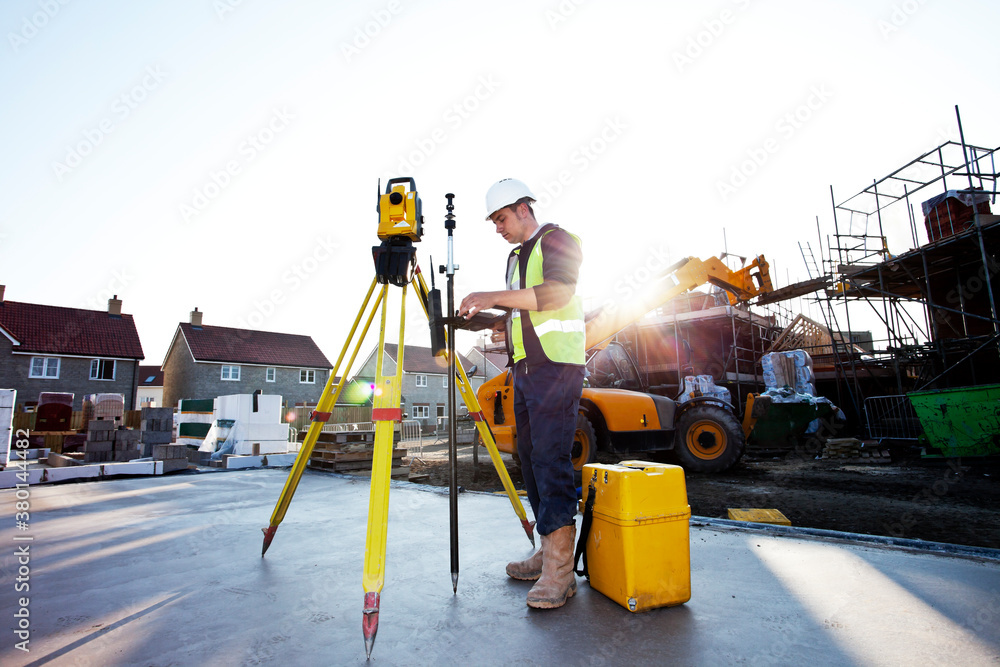 Surveyor using theodolite on building site. Surveyor using theodolite on building site.