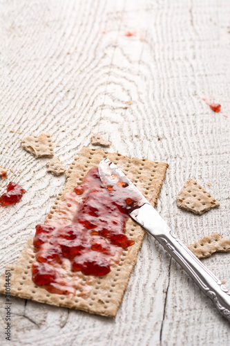 Whole Wheat Jewish Matzah at Passover and Strawberry Preserves photo