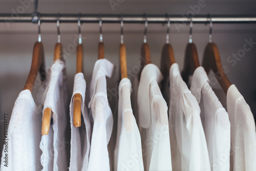 White shirts hanging in a wardrobe photo