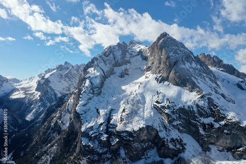 aerial snow covered mountain peaks in alps at winter 