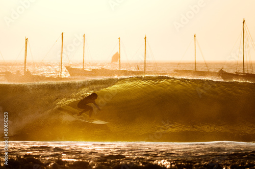 surfer in barreling wave in the port of lobitos, Peru photo