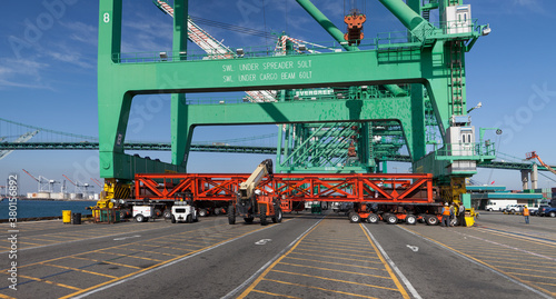 Taking a shipping container crane off a boat photo