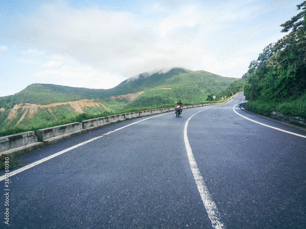 Young man riding a motorbike on the road Young man riding a motorbike on the road