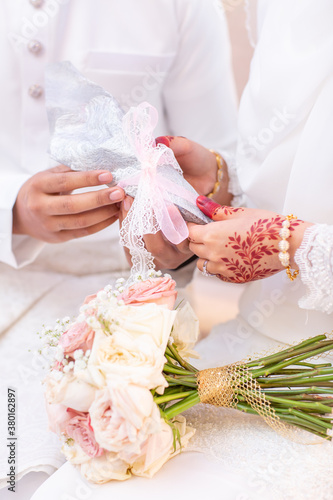 Konstfotografi The groom giving the wedding dowry to the bride