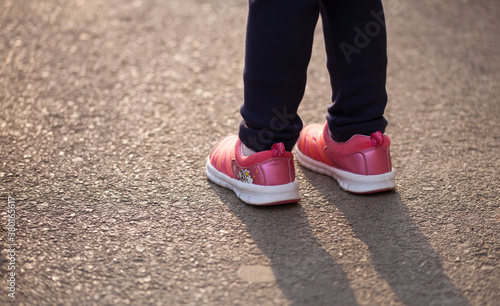 Close-up of child feet wearing shoes outdoors