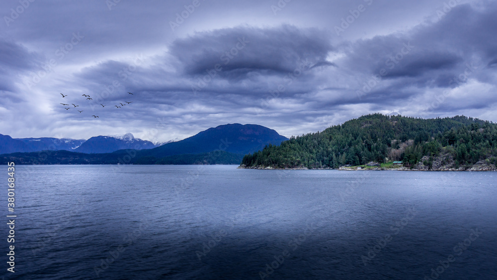 Dark Clouds and a Flock of Birds during a Ferry trip between Horseshoe Bay and Sechelt in British Columbia, Canada