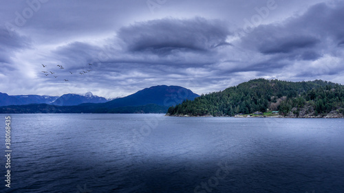 Dark Clouds and a Flock of Birds during a Ferry trip between Horseshoe Bay and Sechelt in British Columbia  Canada