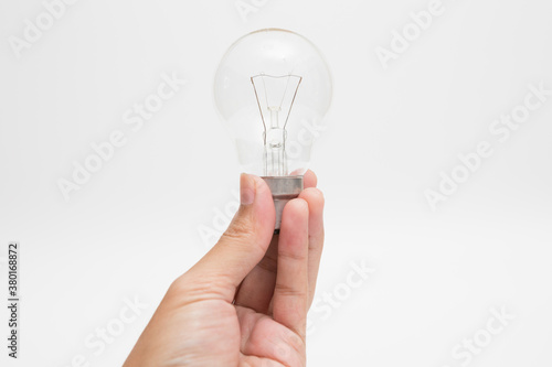 Hand holding a tungsten light bulb  on white background