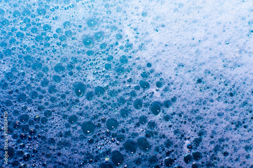abstract background from bubble baths. large and small bubbles on the surface of blue water
