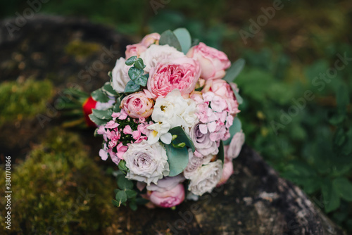 wedding flower bouquet lies on the stump
