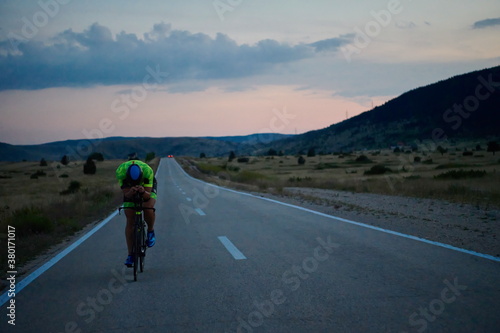triathlon athlete riding bike at night © .shock