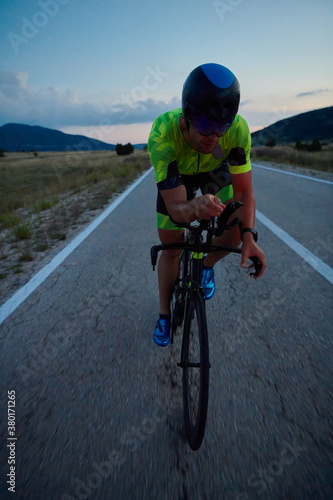 triathlon athlete riding bike at night