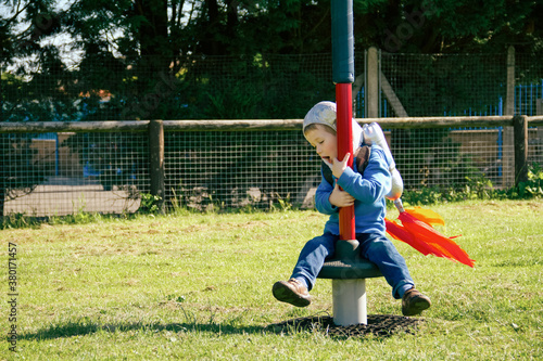 Boy plays in rocket pack costume, pretends to be astronaut photo