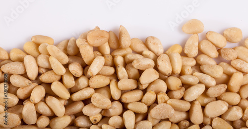 Pile of delicious pine nuts on a white surface. High quality photo