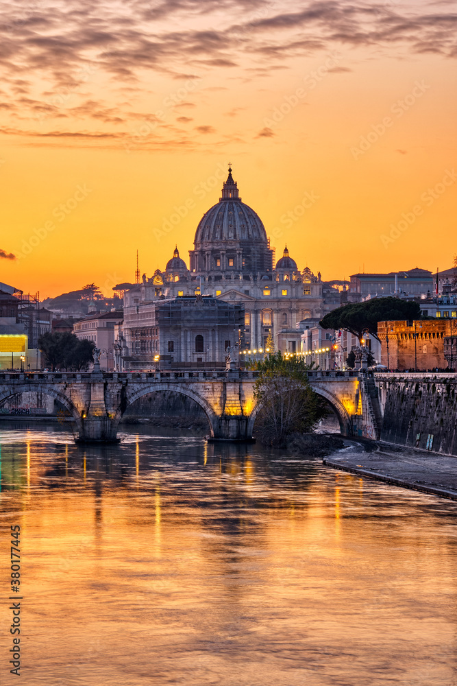 Sunset over the St. Peters Basilica and the river Tiber in Rome