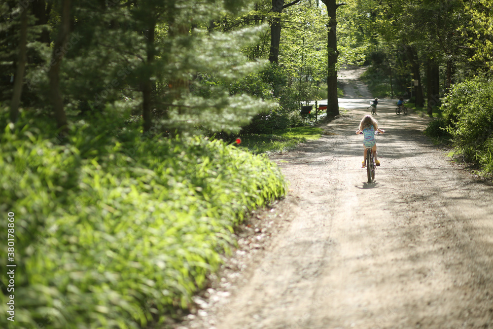 Girl Riding Her Bike Down A Dirt Road Girl Riding Her Bike Down A Dirt Road