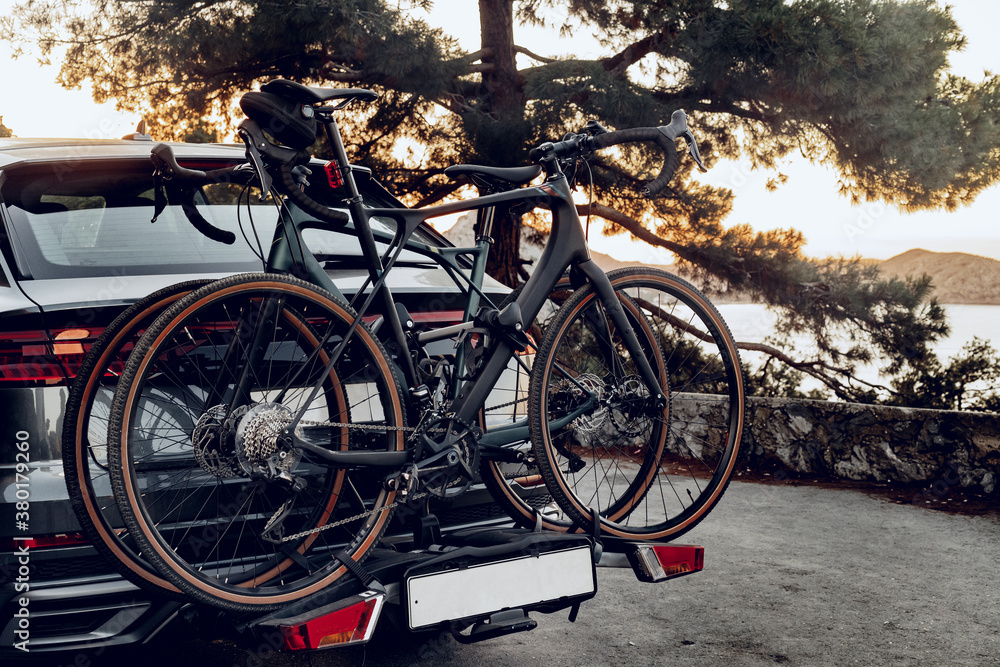 Crossover car with two road bicycles loaded on a rack Crossover car with two road bicycles loaded on a rack