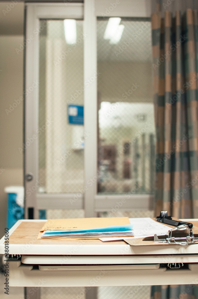 a hospital tray with paperwork and a clipboard a hospital tray with paperwork and a clipboard