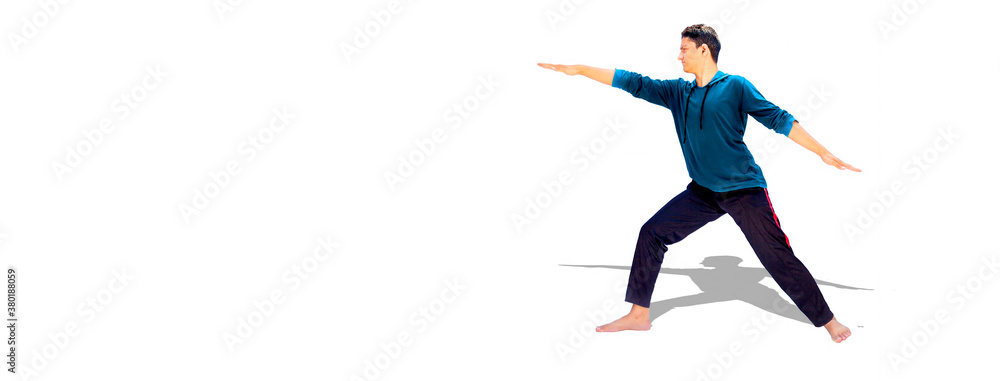 Fototapeta premium A young enthusiastic teenage boy in sportswear isolated with reflection and doing Yoga stretch.