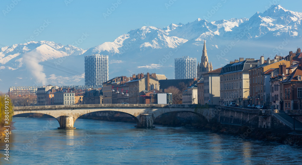 Fototapeta premium Image of cable cars over river and bridge in Grenoble in autumn, France.