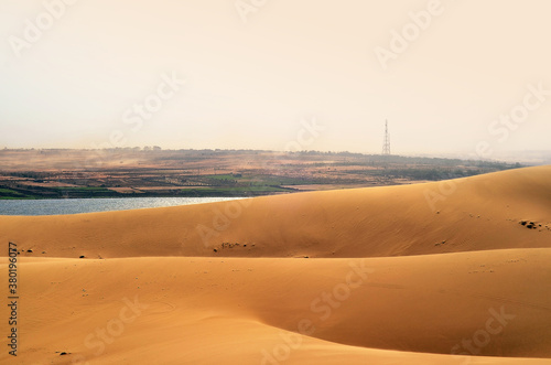 Sand Dunes and a Lake Behind them photo