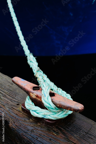 Rope from commercial fishing boat tied to cleat