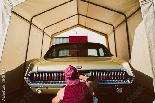 Young man examines his car photo