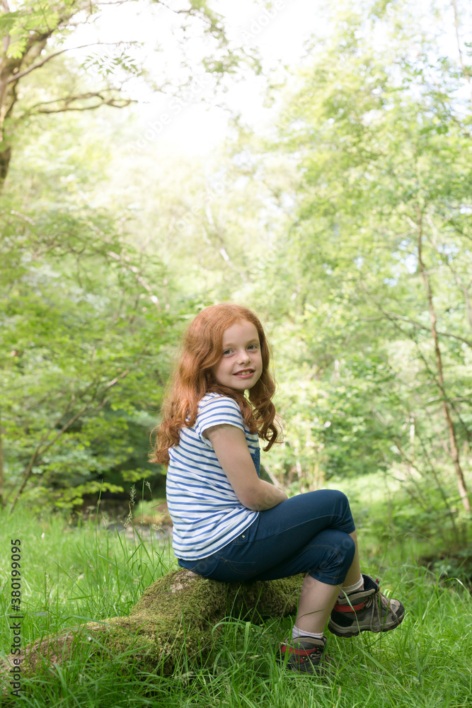 Little girl sitting in the English countryside Little girl sitting in the English countryside