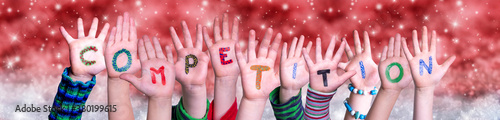 Children Hands Building Colorful English Word Competition. Red Snowy Christmas Winter Background With Snowflakes And Sparkling Lights