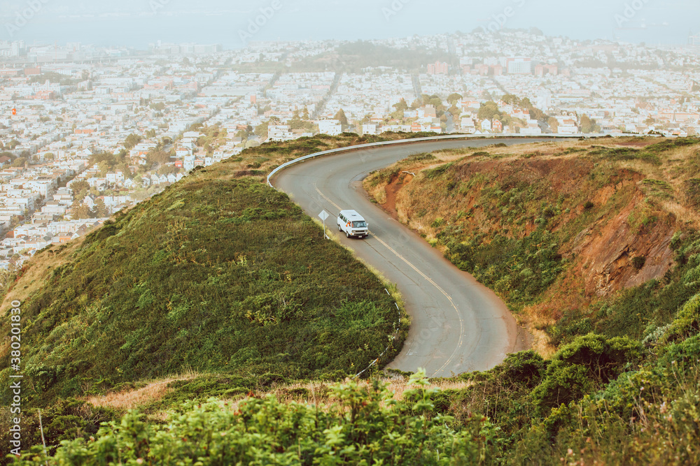 young travelers drive down a windy road in California. young travelers drive down a windy road in California.