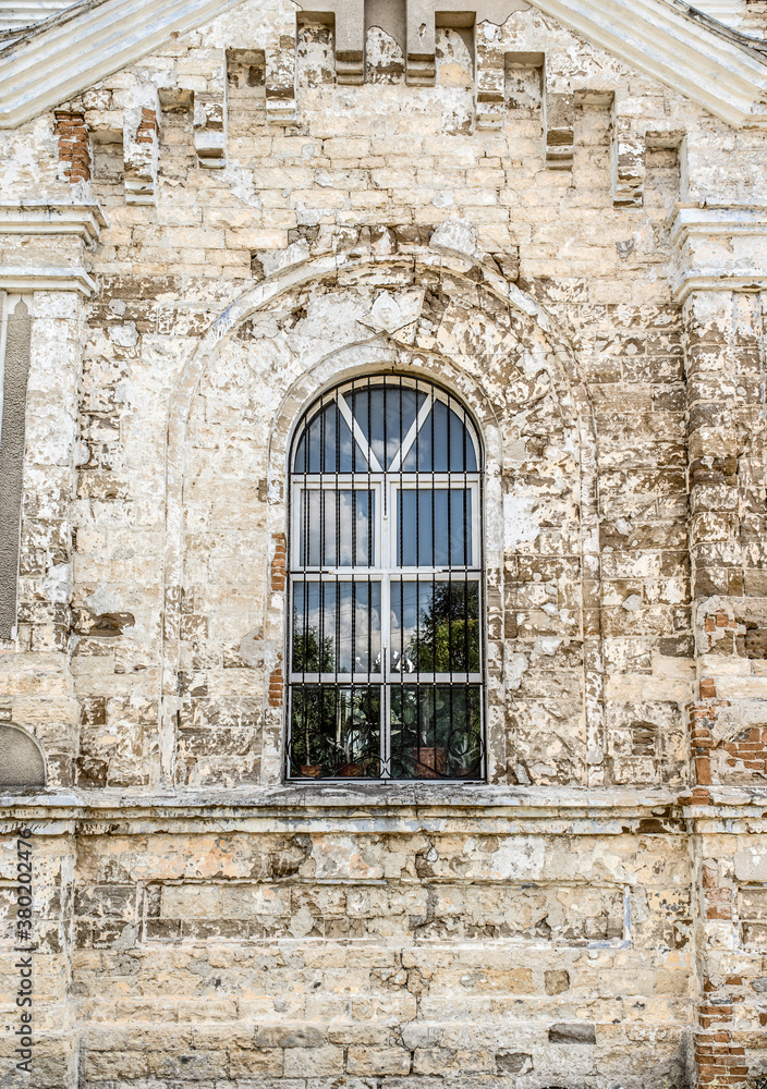 An Old aged building with a window.