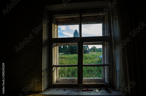 View from the window to the field and forest