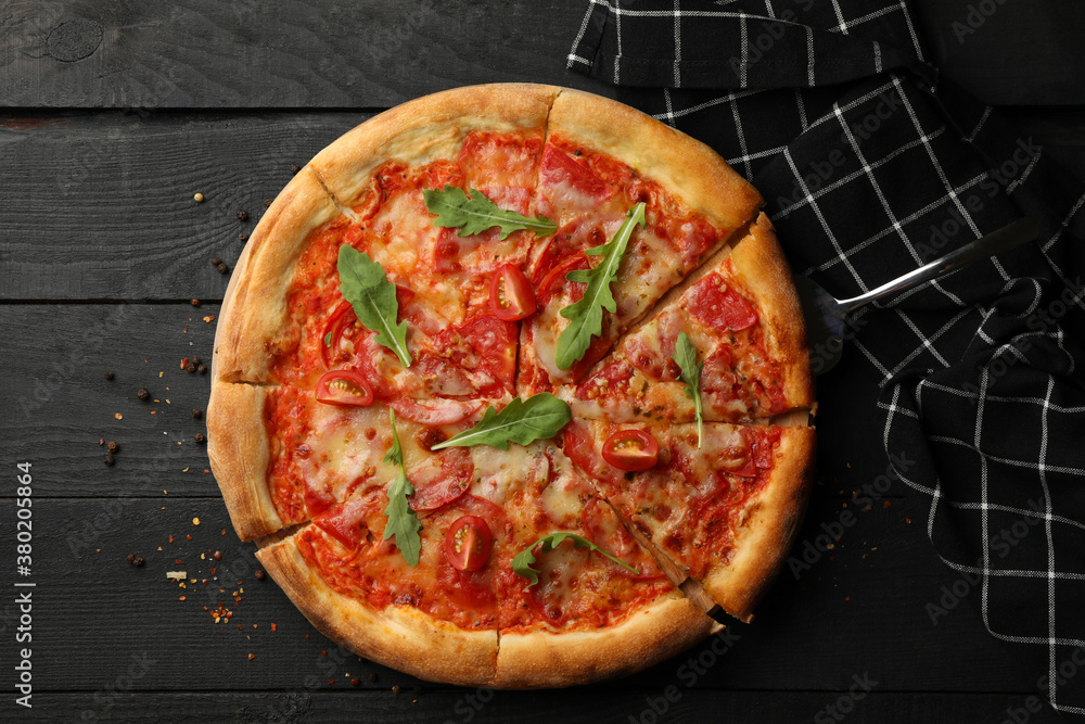 Tasty pizza on wooden background, top view