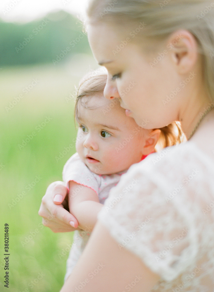 Mother holding her young daughter closely Mother holding her young daughter closely