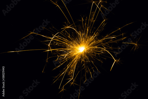 Sparkler on a black background.Close-up of burning sparkler.Fireworks in flame on black background.Christmas sparkler.