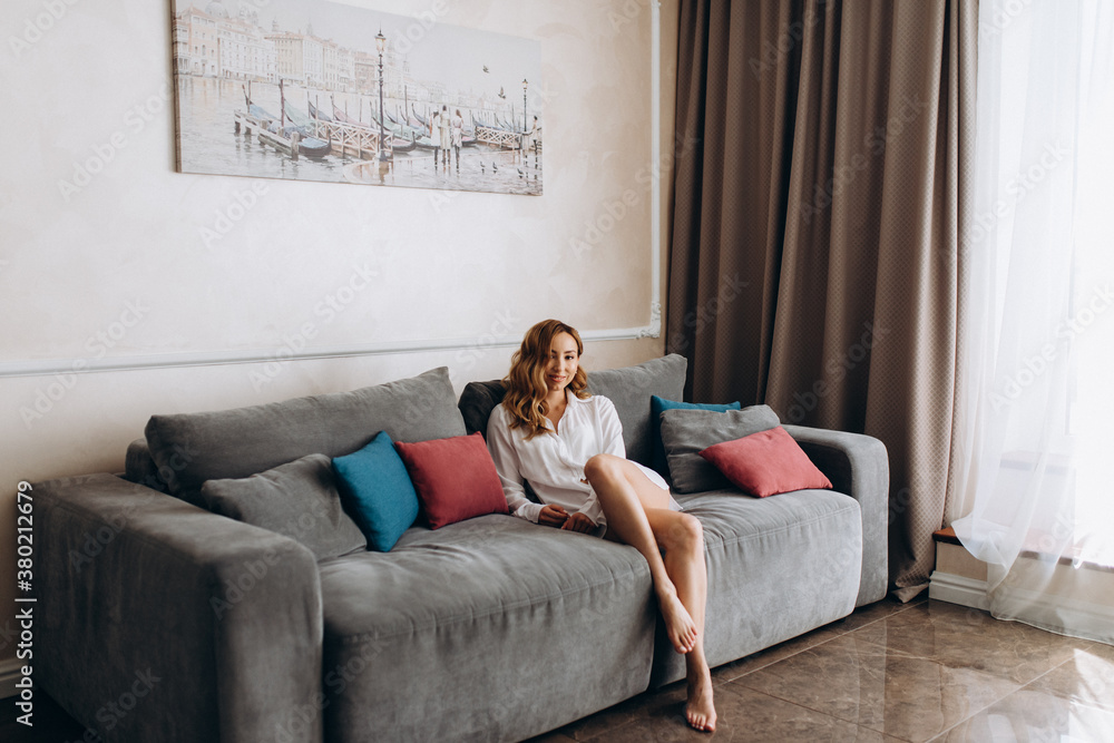 Obraz premium Calm millennial woman relaxing on soft comfortable sofa meditating or having daytime nap, carefree lazy girl breathing fresh air enjoying no stress free peaceful weekend morning resting on couch