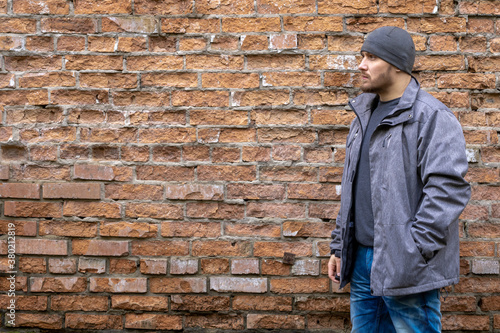 Man on the background of a red brick wall.