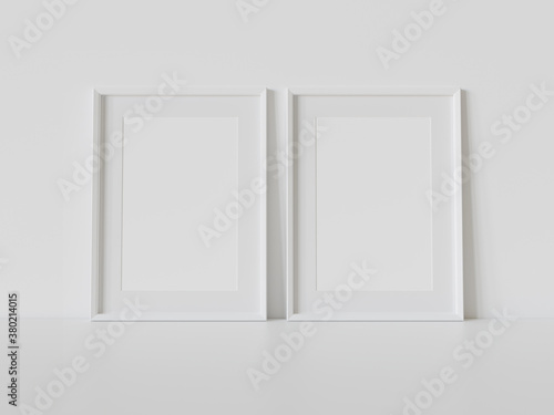 Two white frames leaning on white floor in interior mockup. Template of pictures framed on a wall 3D rendering