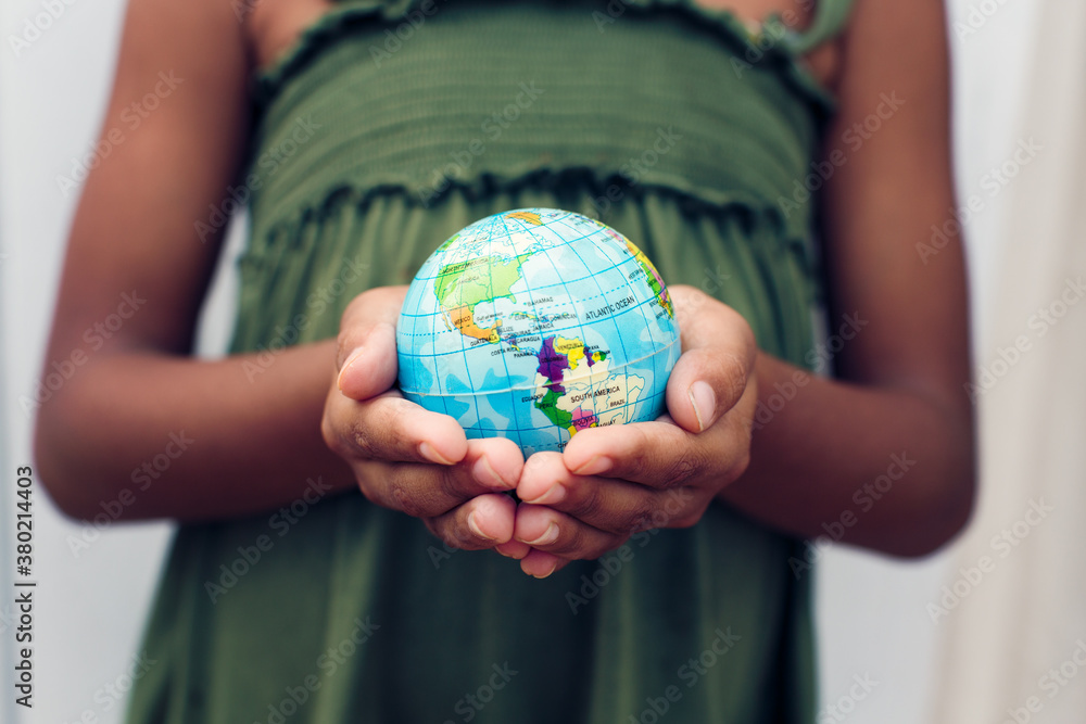 Young girl holding a globe of the world in her hands Young girl holding a globe of the world in her hands