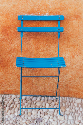 Blue chair on orange wall photo