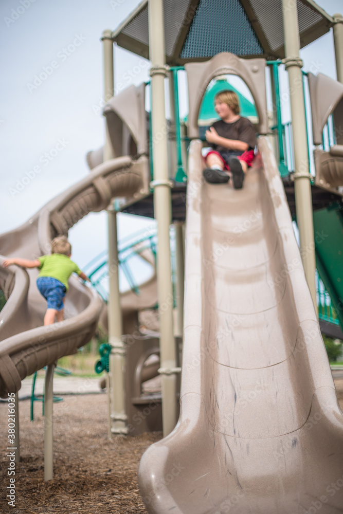 Two Brothers Play together at the Playground Two Brothers Play together at the Playground