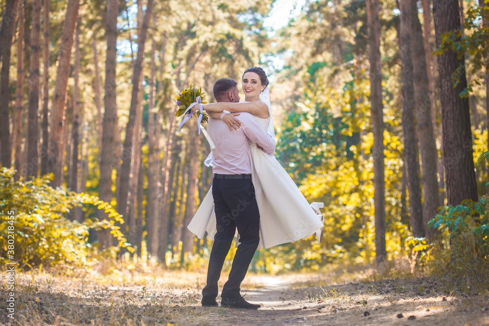 newlyweds are walking in the green park newlyweds are walking in the green park