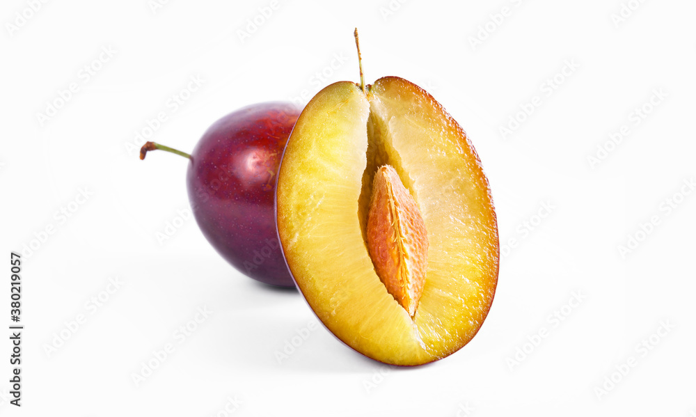 Plum half close up macro shot. Oragnic sweet plums fresh and delicious. Fresh fruit snack. Isolated on white background. - obrazy, fototapety, plakaty 