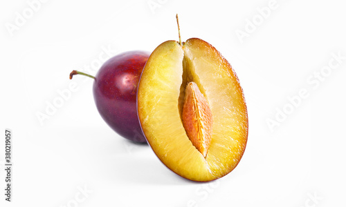 Plum half close up macro shot. Oragnic sweet plums fresh and delicious. Fresh fruit snack. Isolated on white background.